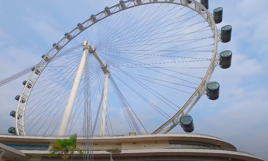 A massive wheel, stretching against a clear sky