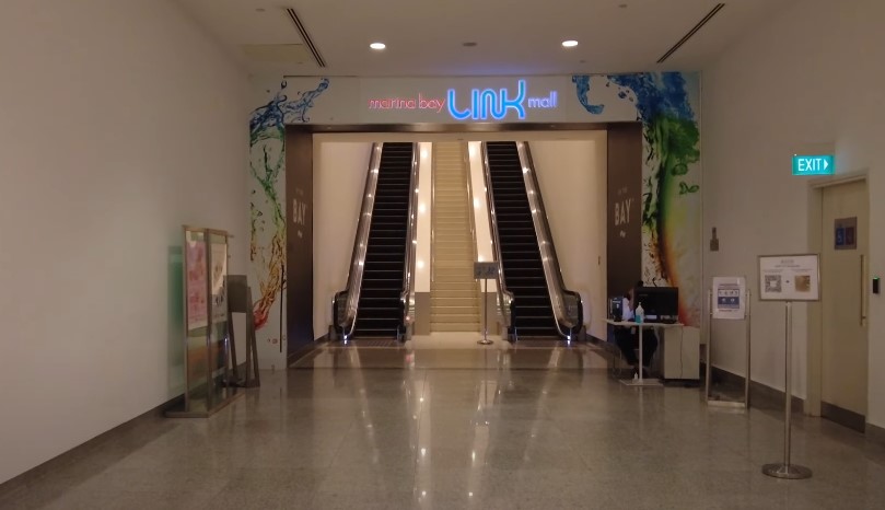 The Link Mall in Marina Bay features a central escalator and staircase area