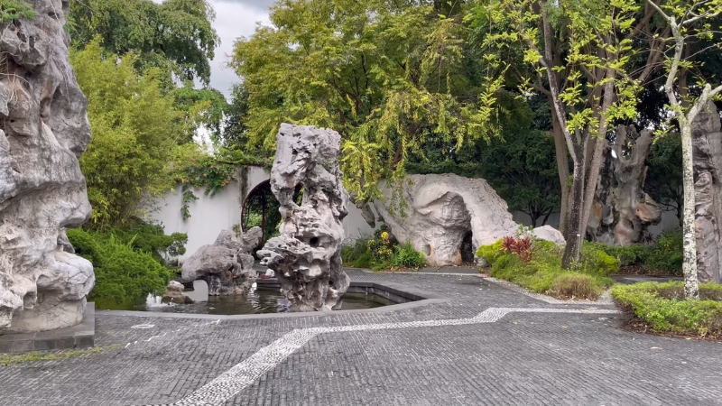 Rock formations, trees, and a small pond create a balanced and peaceful setting in the Chinese Garden