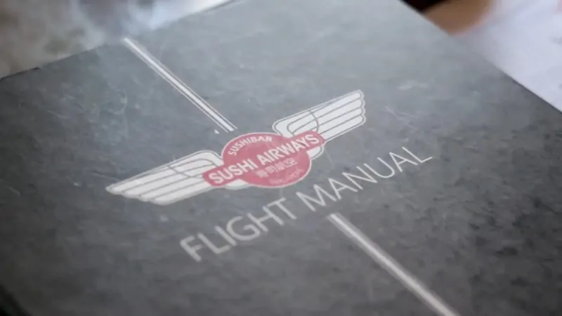 Menu cover of Sushi Airways in Singapore labeled “Flight Manual”