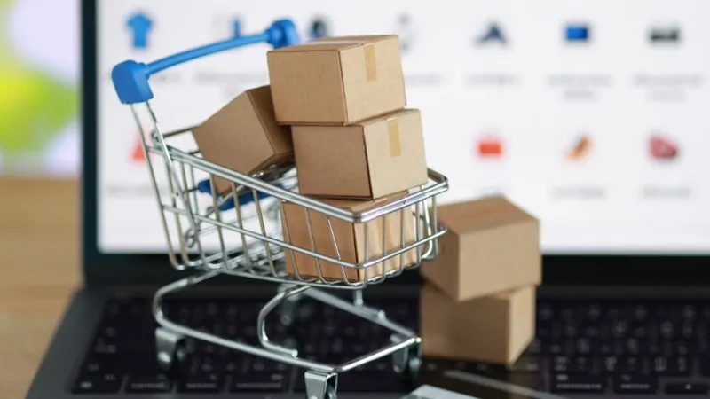 Small boxes in a cart on a laptop screen show e-commerce and niche online retail activity in Singapore