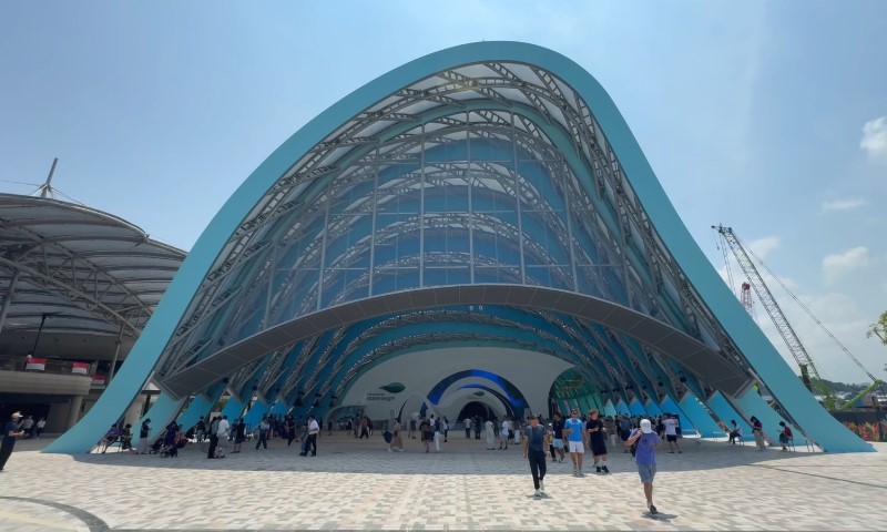 Futuristic building with a large, arched glass and steel facade